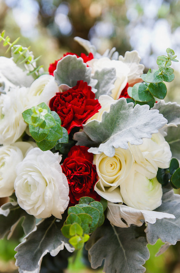 carnations ranunculus roses greenery