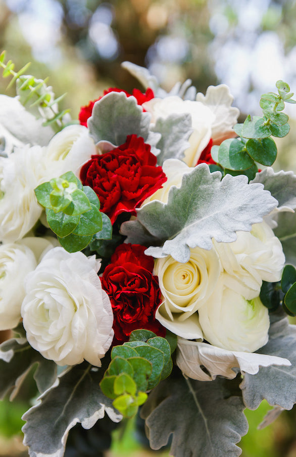 carnations ranunculus roses greenery